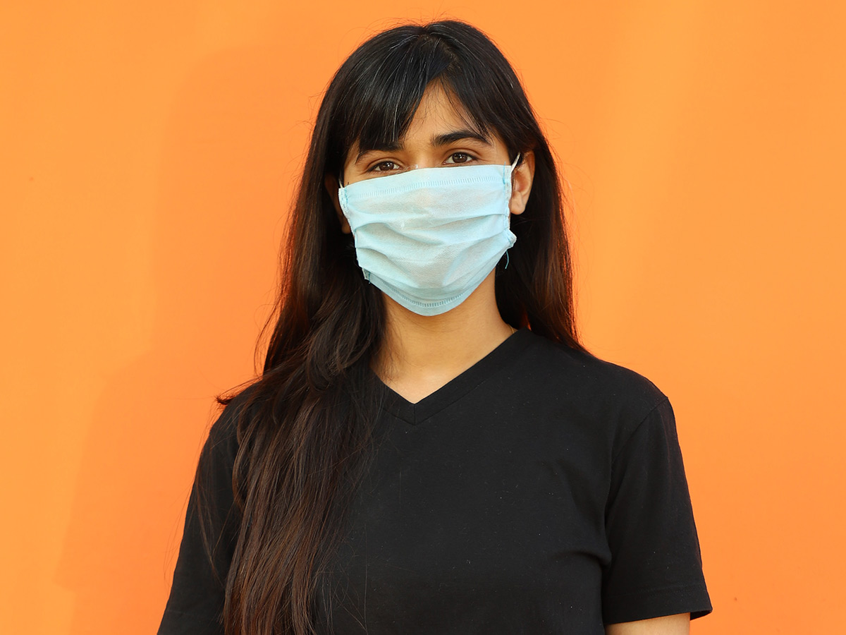 woman in mask smiling