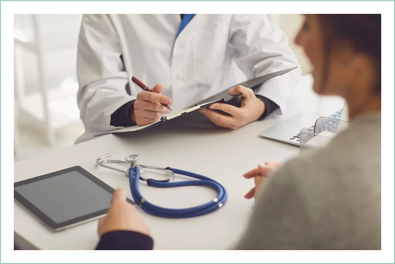 Closeup of doctor's desk with clipboard, tablet, and stethoscope