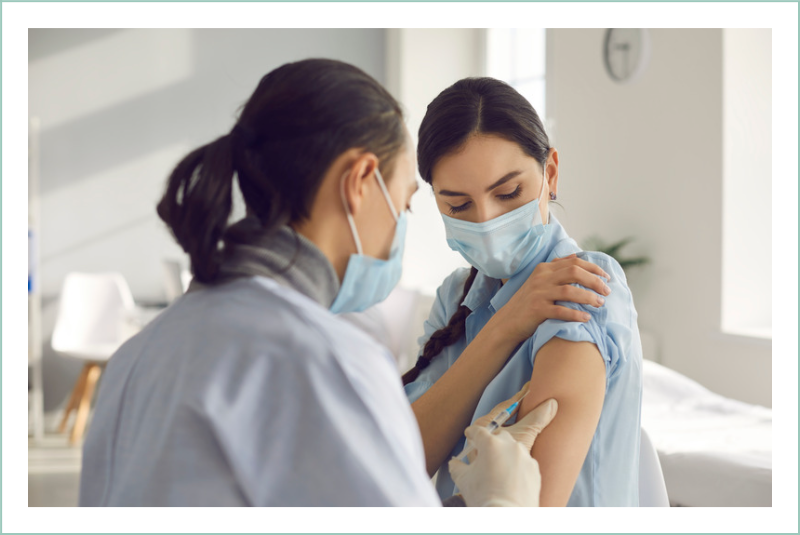 Medical specialist administering a vaccine to a female patient